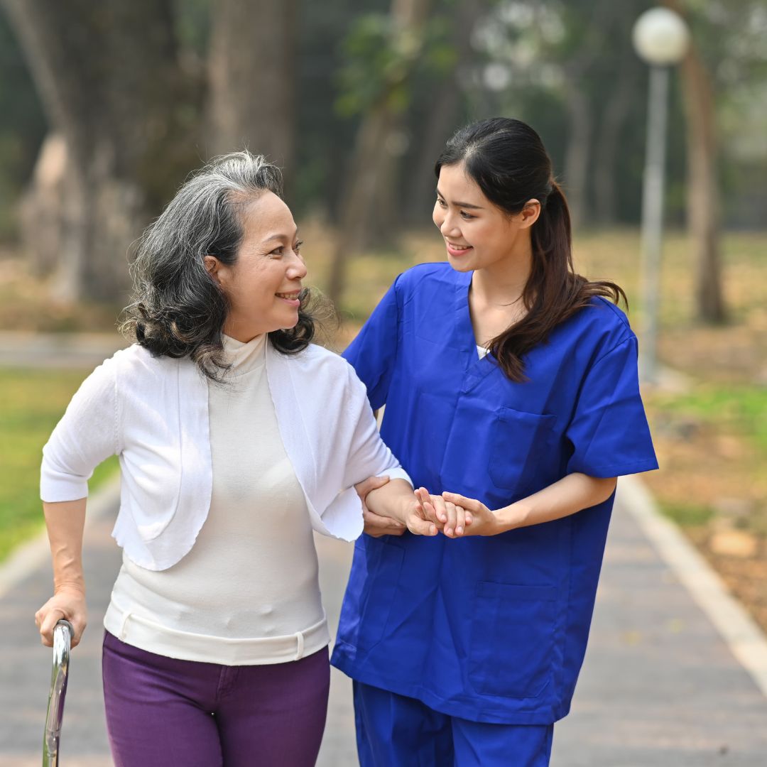dementia carer accompanying elderly man on a walk near his home